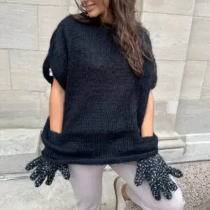 black hand-knitted mohair cape with build-in-glove pockets by New York designer